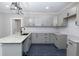 Updated kitchen with sleek gray cabinets, granite counters, black accents and modern pendant lighting at 1174 Donnelly Sw Ave, Atlanta, GA 30310