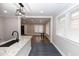 Stylish kitchen featuring granite countertops, black faucet, and modern pendant lighting open to a dining area at 1174 Donnelly Sw Ave, Atlanta, GA 30310