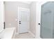 Bright laundry room with laundry themed glass door, decorative patterned tile, and ample storage and counter space at 1174 Donnelly Sw Ave, Atlanta, GA 30310