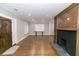 Spacious living room with hardwood floors, fireplace, front door, and multiple windows at 1174 Donnelly Sw Ave, Atlanta, GA 30310