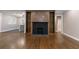 Open living room layout with a fireplace, built-in shelving, and view into the kitchen at 1174 Donnelly Sw Ave, Atlanta, GA 30310