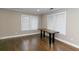 Bright living room with wood floors, white trim, and two large windows at 1174 Donnelly Sw Ave, Atlanta, GA 30310