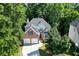 Beautiful aerial view of a two-story brick home surrounded by mature trees at 1614 Summersweet Ln, Dacula, GA 30019