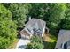 Stunning aerial view of a two-story brick home surrounded by lush greenery at 1614 Summersweet Ln, Dacula, GA 30019