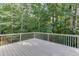 Open-air backyard deck offering a private view into the surrounding woods at 1614 Summersweet Ln, Dacula, GA 30019