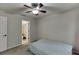 Bright bedroom with ceiling fan, neutral-colored carpet, and en suite bathroom at 1614 Summersweet Ln, Dacula, GA 30019