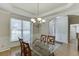 Beautiful dining room featuring a chandelier, large window, and tray ceiling at 1614 Summersweet Ln, Dacula, GA 30019