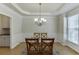 Elegant dining room with tray ceiling, chandelier, and large window at 1614 Summersweet Ln, Dacula, GA 30019