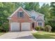 Charming two-story brick home with a two-car garage and well-maintained lawn at 1614 Summersweet Ln, Dacula, GA 30019