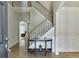 Bright foyer with hardwood floors, staircase, and decorative console table at 1614 Summersweet Ln, Dacula, GA 30019