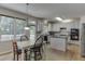 Bright kitchen and dining area with hardwood floors, stainless appliances, and an island at 1614 Summersweet Ln, Dacula, GA 30019