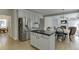 An open-concept kitchen features granite countertops, an island, and stainless steel appliances at 1614 Summersweet Ln, Dacula, GA 30019