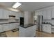 A large kitchen with an island, stainless steel appliances, and granite countertops at 1614 Summersweet Ln, Dacula, GA 30019