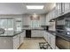 A spacious kitchen with an island, granite countertops, and stainless steel appliances at 1614 Summersweet Ln, Dacula, GA 30019