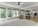 Bright living room with large windows open to a kitchen and breakfast area at 1614 Summersweet Ln, Dacula, GA 30019