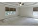 A large main bedroom with windows and a ceiling fan at 1614 Summersweet Ln, Dacula, GA 30019