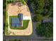 Aerial view of a home with a large yard surrounded by mature trees and a long driveway at 1943 Lake Chase Ln, Jonesboro, GA 30236