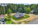 Aerial view shows the home's exterior with new lawn, landscaping, and large trees in the neighborhood at 1943 Lake Chase Ln, Jonesboro, GA 30236