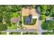 An aerial view reveals the home, green lawn, and adjacent vacant land, with surrounding mature trees at 1943 Lake Chase Ln, Jonesboro, GA 30236