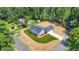 Aerial view shows the home's exterior, new lawn, vacant lot, and surrounding wooded neighborhood at 1943 Lake Chase Ln, Jonesboro, GA 30236