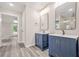 This bathroom features double vanities, chrome fixtures, and modern lighting at 1943 Lake Chase Ln, Jonesboro, GA 30236