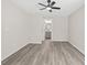 Bedroom showcases gray wood floors, light gray walls, ceiling fan, and access to an ensuite bath at 1943 Lake Chase Ln, Jonesboro, GA 30236