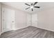 This bedroom features a ceiling fan and stylish gray wood flooring at 1943 Lake Chase Ln, Jonesboro, GA 30236
