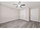 Neutral bedroom with gray flooring, a ceiling fan, and bright white trim at 1943 Lake Chase Ln, Jonesboro, GA 30236