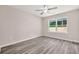 Bright bedroom with a ceiling fan and a large window showing outdoor views at 1943 Lake Chase Ln, Jonesboro, GA 30236