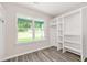 Walk-in closet with custom built-in shelving and outside view at 1943 Lake Chase Ln, Jonesboro, GA 30236