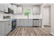 Modern kitchen with stainless appliances, granite counters and gray cabinets at 1943 Lake Chase Ln, Jonesboro, GA 30236