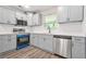 This kitchen features gray cabinets, stainless steel appliances, and bright white countertops at 1943 Lake Chase Ln, Jonesboro, GA 30236