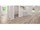 A kitchen with grey cabinets, open pantry, and wood-look flooring with bright natural light at 1943 Lake Chase Ln, Jonesboro, GA 30236