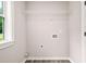 Bright laundry area with storage rack at 1943 Lake Chase Ln, Jonesboro, GA 30236