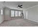 Large bedroom featuring three large windows, neutral colors, and ceiling fan at 3415 Crop Corner Rd, Suwanee, GA 30024