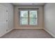 Empty bedroom with neutral carpet and two windows, ready to be furnished at 3415 Crop Corner Rd, Suwanee, GA 30024