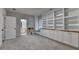 Bonus room featuring carpeted floor, built-in shelving, a window seat and a door leading to a bathroom at 3415 Crop Corner Rd, Suwanee, GA 30024