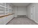 Bright bonus room featuring carpeted floor, built-in shelving and base cabinet providing plenty of storage space at 3415 Crop Corner Rd, Suwanee, GA 30024