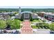 Aerial view of a classic City Hall building with well-manicured grounds, trees and charming surrounding streetscape at 3415 Crop Corner Rd, Suwanee, GA 30024