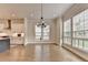 Dining room with hardwood floors, large windows, and modern chandelier at 3415 Crop Corner Rd, Suwanee, GA 30024