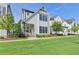 Charming two-story home with white siding, black framed windows and well-manicured lawn at 3415 Crop Corner Rd, Suwanee, GA 30024