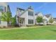 Charming two-story home with white siding, black framed windows and well-manicured lawn at 3415 Crop Corner Rd, Suwanee, GA 30024