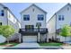 Beautiful home exterior featuring a private balcony, a two-car garage, and manicured lawn at 3415 Crop Corner Rd, Suwanee, GA 30024