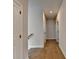 Neutral hallway with wood floors and white doors leading to other rooms in the house at 3415 Crop Corner Rd, Suwanee, GA 30024