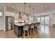 Bright kitchen featuring stainless appliances, white cabinets, large island with seating, and hardwood floors at 3415 Crop Corner Rd, Suwanee, GA 30024