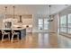 Open-concept kitchen with stainless appliances, island seating, and hardwood floors at 3415 Crop Corner Rd, Suwanee, GA 30024