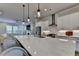 Stylish kitchen featuring stainless steel appliances, white cabinets, and a modern range hood at 3415 Crop Corner Rd, Suwanee, GA 30024