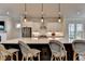 Bright kitchen area with bar stool seating, stainless appliances, and modern pendant lighting at 3415 Crop Corner Rd, Suwanee, GA 30024