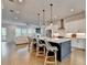 Open kitchen features a large island with seating, modern appliances, and a view into the living room at 3415 Crop Corner Rd, Suwanee, GA 30024