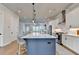 Modern kitchen with large island, stainless steel appliances, and open view to the living room at 3415 Crop Corner Rd, Suwanee, GA 30024